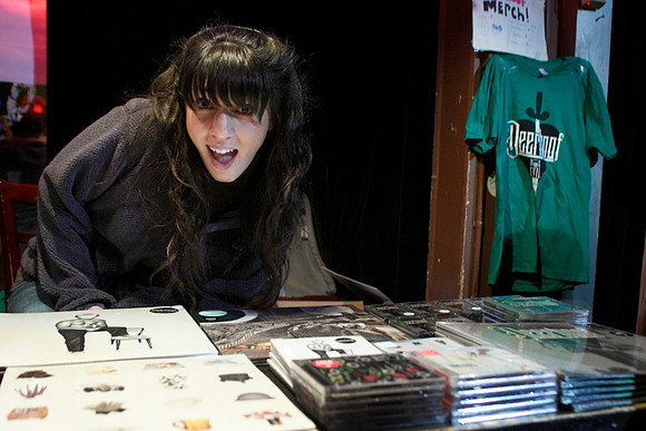 Kate Bell plays Merch Girl